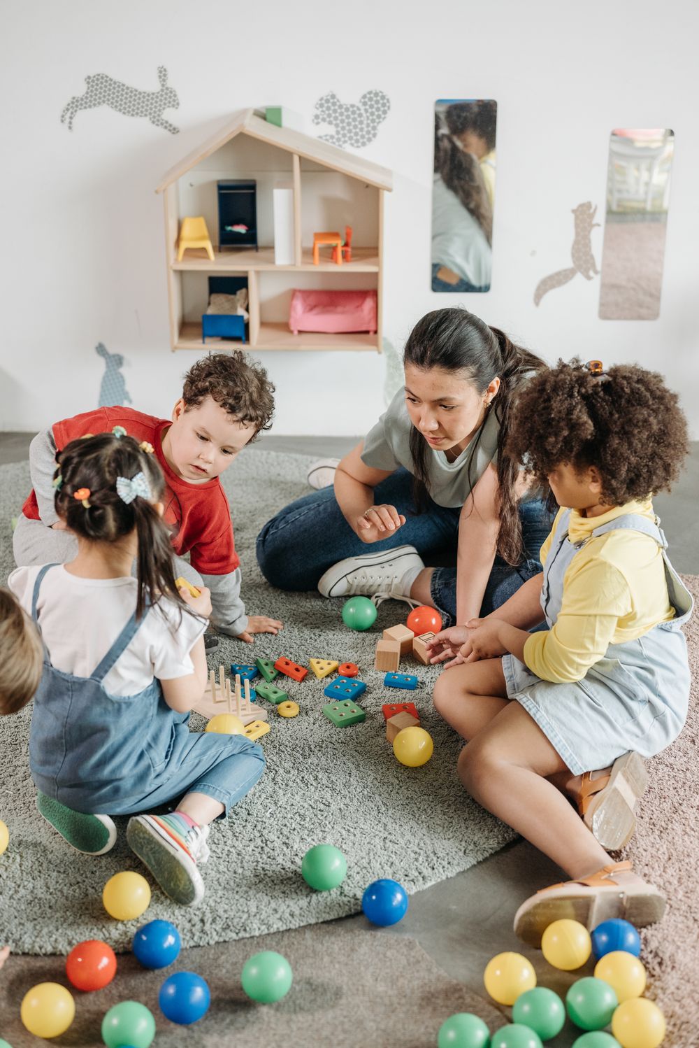 Children playing with a teacher